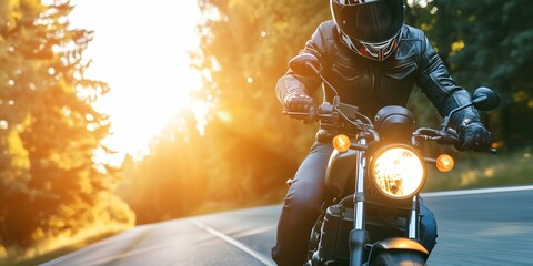 Biker in helmet and leather jacket riding on motorcycle on country road. - obrazy, fototapety, plakaty