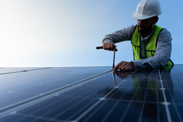 low angle portrait of a confident engineer looking at camera, technician standing between solar...
