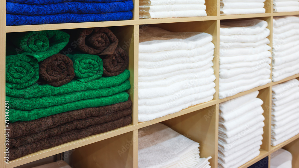 Poster multi-colored towels on a shelf in a store