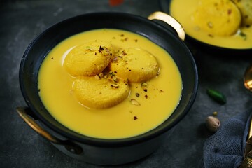 Mango Rasmalai topped with pistachios, selective focus | Indian desserts