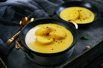 Mango Rasmalai topped with pistachios, selective focus | Indian desserts