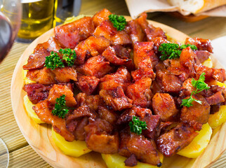 Traditional Galician fair dish of braised pig snouts served with sliced cooked potatoes, smoked...