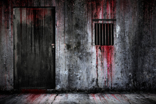 Bloody background scary old cement wall and floor, and the door, and window with rusted iron bars, the concept of horror and Halloween