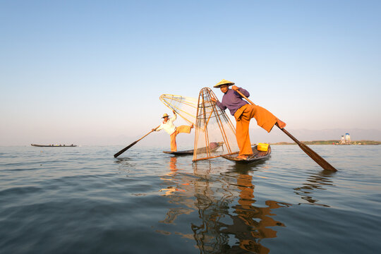Two local Intha fishermen fishing on Inle lake, Myanmar