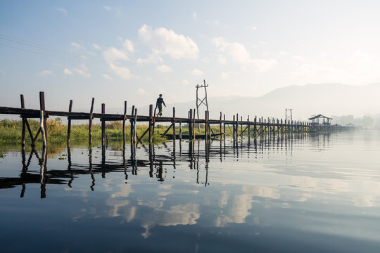 Man walking on wooden bridge, Inle lake, Myanmar