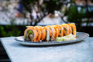 sushi maki roll with avocado salmon and sliced ​​shrimp