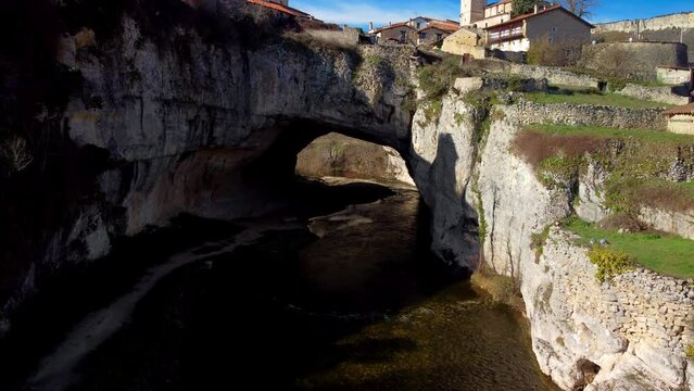 Aerial view of Puentedey, a picturesque village with a natural bridge over the river. Burgos, Spain. High quality 4k footage