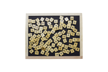 English letters made from square wooden tiles There are English letters scattered on a black background. Concepts for developing grammar thinking