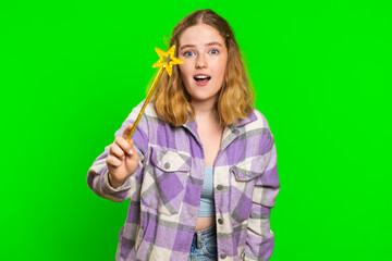 Magician witch young woman gesturing with magic wand fairy stick, making wish come true, casting magician spell, advertising holidays sale discount. Caucasian girl isolated on chroma key background