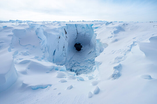 Hole in frozen ice of Antarctica, tunnel passage to hollow earth, artist's impression, theory