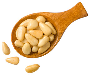 Roasted pine nuts in the wooden spoon, isolated on the white background, top view.