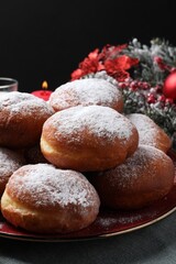 Delicious sweet buns on table against black background, closeup