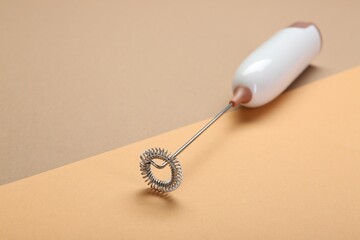 White milk frother wand on color background, space for text