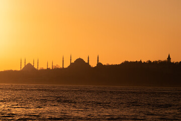 Naklejka premium View of Istanbul's historical peninsula at sunset. View of the Sultanahmet Mosque located on the historical peninsula in silhouette.
