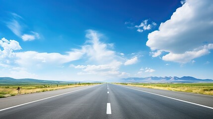 Fototapeta premium asphalt road with white lines, sunny view, blue sky with clouds above,