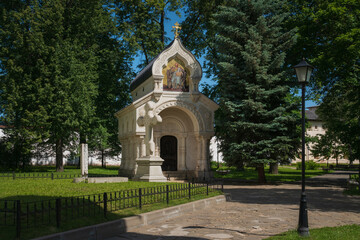 View of the monument-chapel of D.M. Pozharsky with a memorial cross in the architectural and museum complex of the Spaso-Evfimiev Monastery on a sunny summer day, Suzdal, Vladimir region, Russia