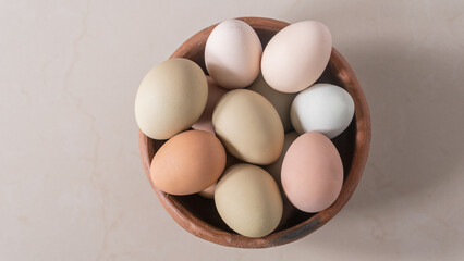 Basket of chicken eggs on the table, colorful big eggs, organic food, natural protein