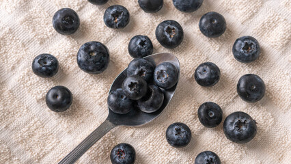 High angle view of fresh blueberries and spoon on table 