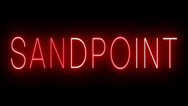 Flickering red retro style neon sign glowing against a black background for SANDPOINT