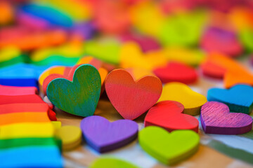 traditional Valentine's Day elements with LGBTQ+ pride, such as rainbow-colored hearts, to convey a message of love and unity for the entire spectrum of identities