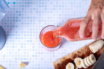 Serving a healthy homemade fruit smoothie.