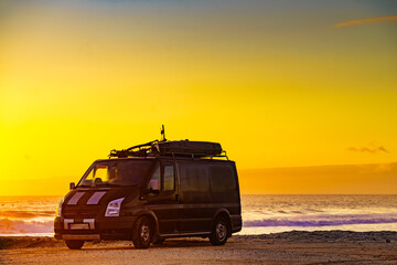 Fototapeta na wymiar Camper van on beach at sunrise