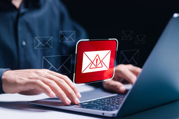 Person use laptop displays Email spam icon, junk, and e-marketing. Receive alerts for Email spam...