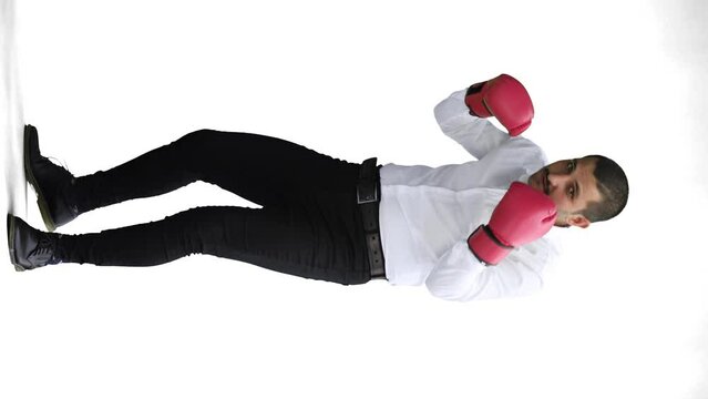 man in full growth. isolated on a white background in business clothes with boxing gloves