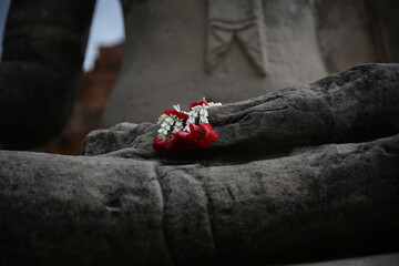 buddha statue holding a flower