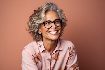 Portrait of a happy senior woman with eyeglasses over brown background