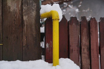 the yellow pipe that supplies a house with gas in the cold season. detail.