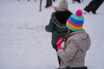 children playing with snowballs. winter landscape.