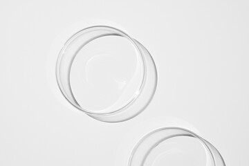 top view shot of a petri dish with liquid bubbles oil on a white background. hard lighting hard...