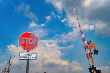 one package of stop signs and gate barriers at railway crossings in Indonesia.