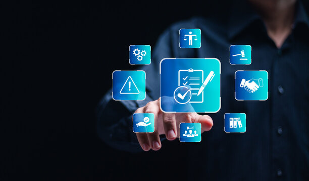 Compliance in business concept.  Businessman touch compliance icon on virtual screen, ensuring the enforcement of laws, regulations, and standards. Stay in line with business policies