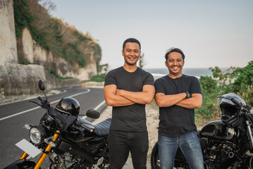 Fototapeta na wymiar asian men rider standing beside motorcycle with crossed arms