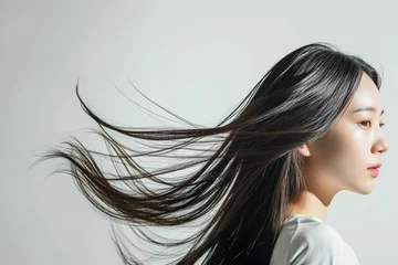  黒髪の綺麗な日本人女性の横顔の写真（ヘアケア・ロングヘア・縮毛矯正・ストレート・背景なし） © Maki_Japan