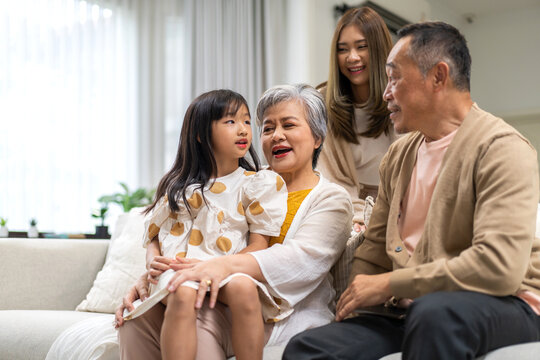 Portrait of happy love family asian father and mother playing with adorable asian kid girl.daughter, care, insurance.Happy family moments good time love with grandparents.Love of big family.