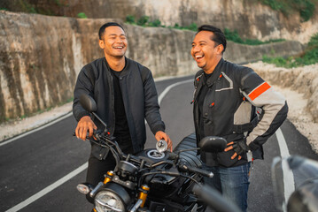 Fototapeta na wymiar indonesian riders doing fuel tank inspection with laughing face