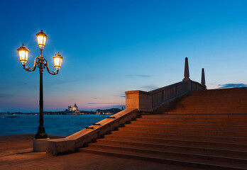Idyllic landscape of street lamp, bridge and canal in Venice, Italy