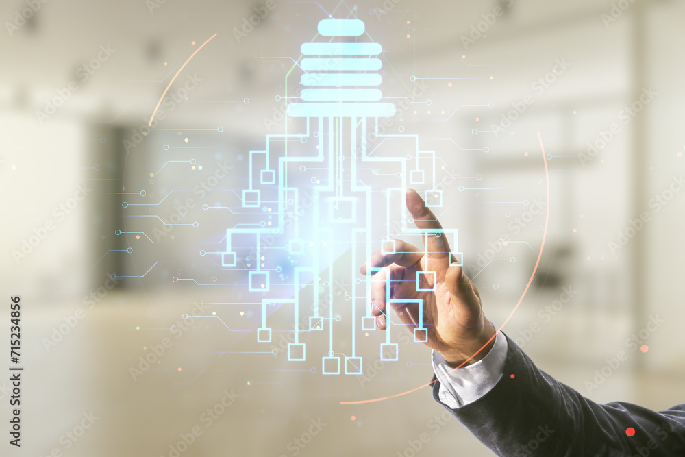 Poster developer's hand clicks on virtual creative light bulb illustration with microcircuit on blurred off