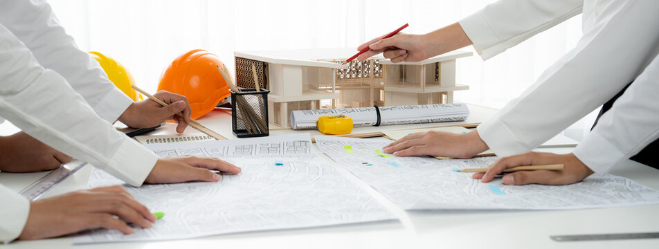 Worker, architect and engineer work on real estate construction project oratory planning with cartography and cadastral map of urban town area to guide to construction developer business plan of city