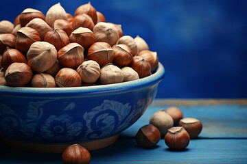Generative AI Image of Hazelnuts in a Bowl on Blue Background