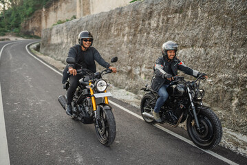 Fototapeta na wymiar indonesian riders on jacket and helmet traveling on the street by motorbike