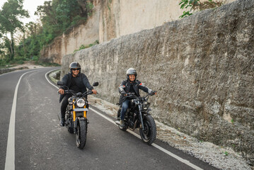 asian men riding motorbike on the street around countryside
