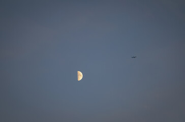 Plane flying across the moon