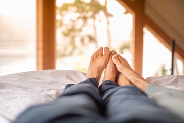Couple's feet snuggling in the bed sowing love and affection 