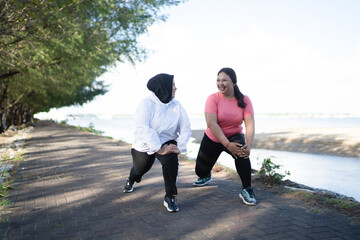 outdoor healthy activity of asian women in sportswear warming up