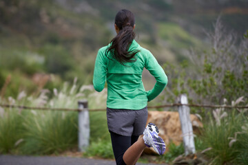 Back, road and running with woman, fitness and morning with fresh air and exercise for health, wellness and cardio. Person, runner or athlete with workout or training with nature, energy or challenge