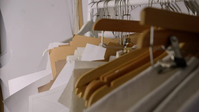 Sewing pattern templates on hangers in fashion designer studio. Close up.
